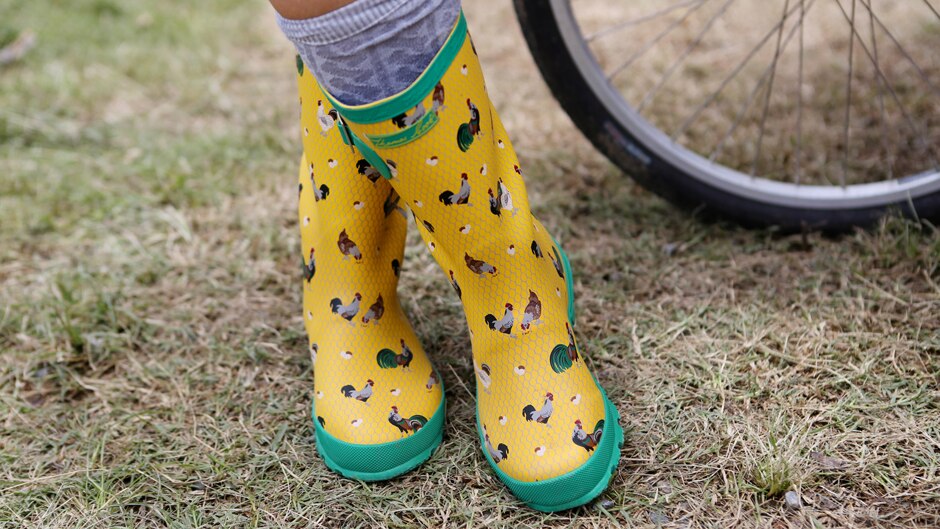 Yellow gumboots covered in pictures of chickens.