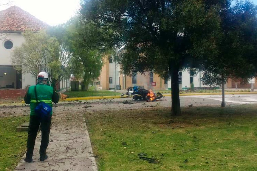 Flames rise from a deadly car bombing at Bogota police academy.