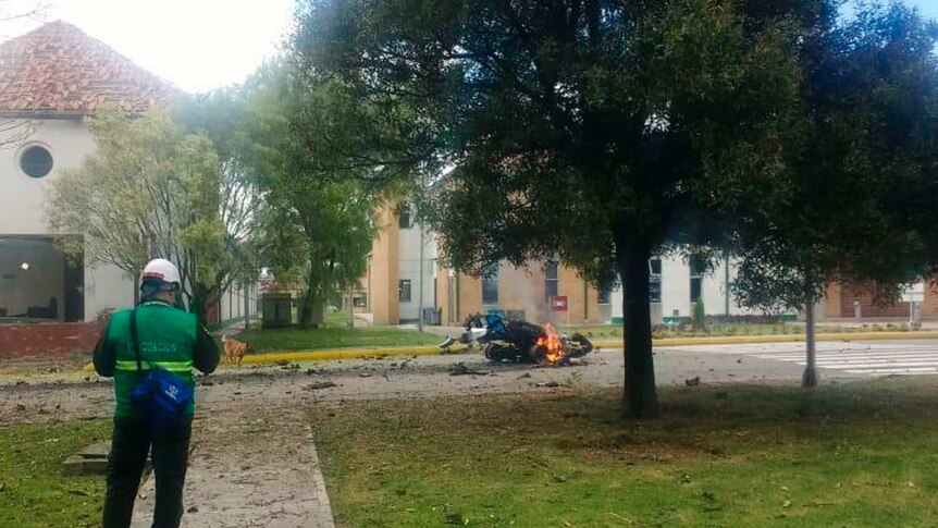 Flames rise from a deadly car bombing at Bogota police academy.