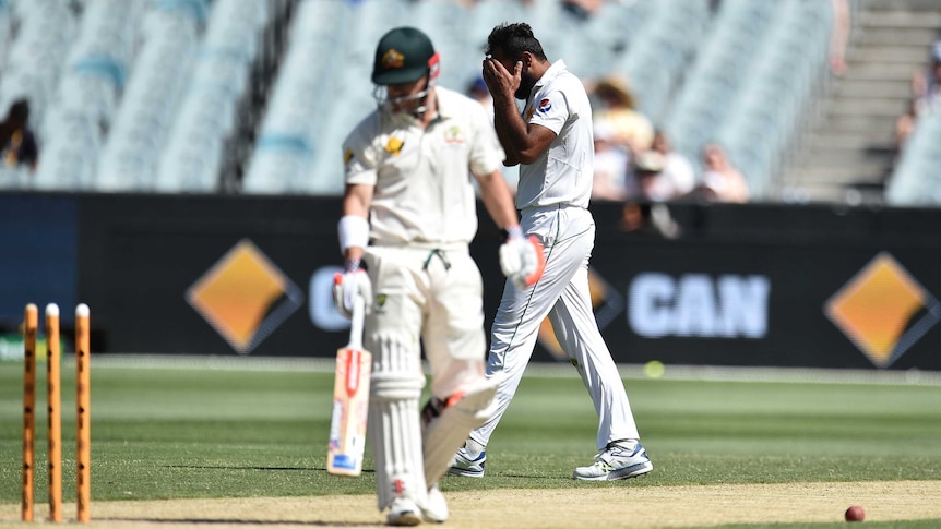 Pakistan's Wahab Riaz (R) reacts after he bowled David Warner off a no-ball at the MCG in 2016.