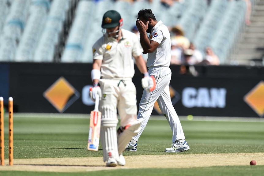 Pakistan's Wahab Riaz (R) reacts after he bowled David Warner off a no-ball at the MCG in 2016.