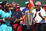 Serena Williams speaks next to Indian Wells tournament chief Raymond Moore after 2016 women's final.