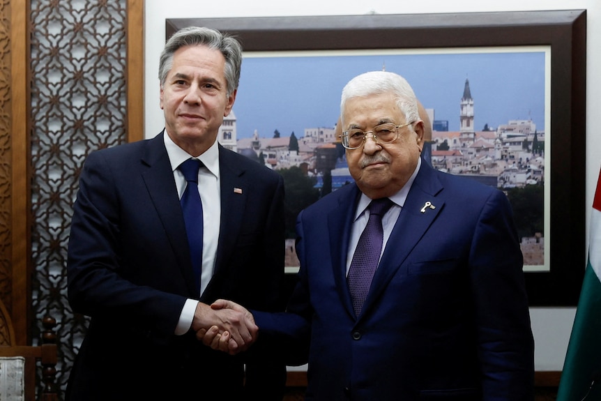 two men in suits shaking hands, antony blinken on the left, abbas on the right