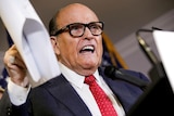 Former NYC mayor and Donald Trump's erstwhile personal attorney Rudy Giuliani gestures at a press conference in 2