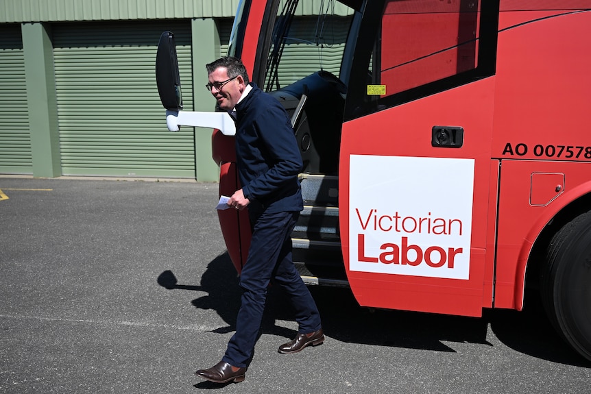 Victorian Premier Daniel Andrews exits the campaign bus ahead of a tour and press conference.