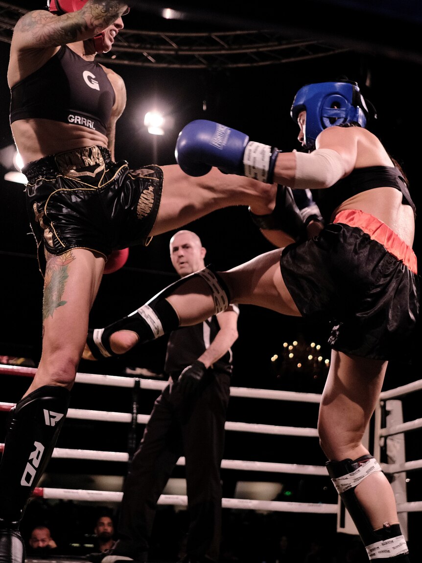 Fighter Jenny Valentish in a boxing ring fighting another opponent.