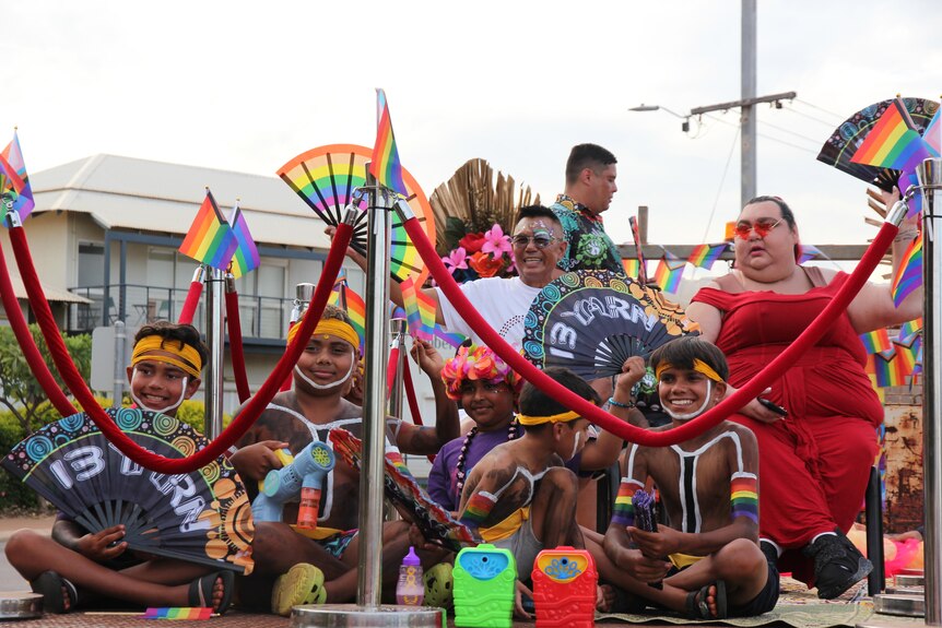 Children and Blak Pride performers sit on float in Broome. 