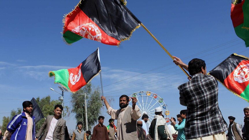 Afghan cricket fans fly flags on the street