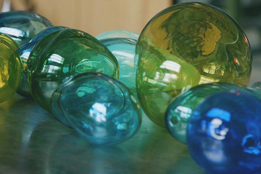 Blue and green glass artworks by Tasmanian artist Keith Dougall.