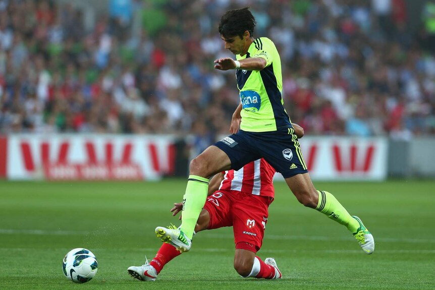 Melbourne Victory's Gui Finkler avoids a tackle from the Heart's Fred.
