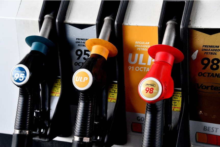 Nozzles labeled with different types of fuel are seen at a filling station in Sydney.