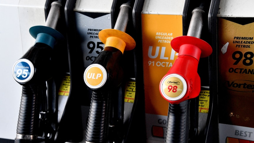 Nozzles labeled with different types of fuel are seen at a filling station in Sydney.