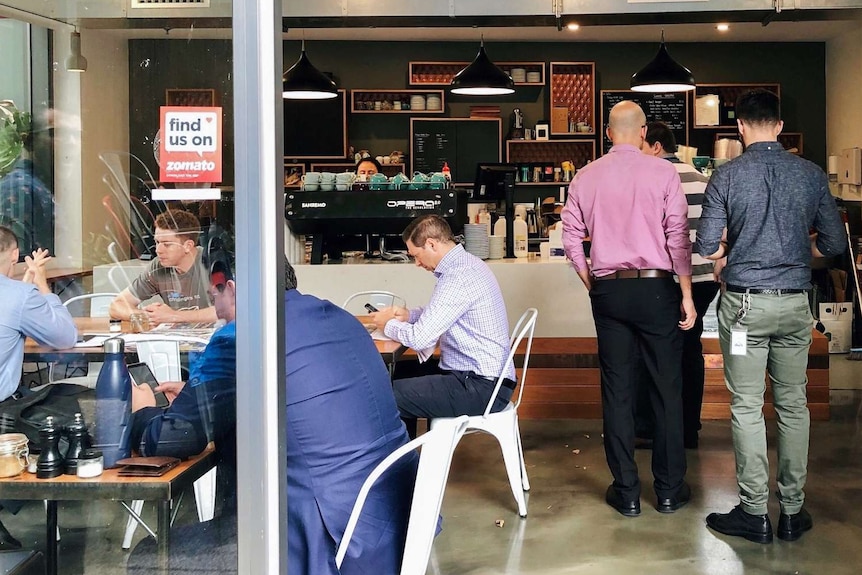 People waiting for coffee in a cafe.