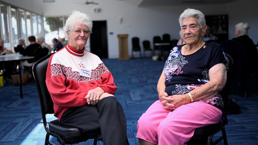 Two elderly women sitting in chairs