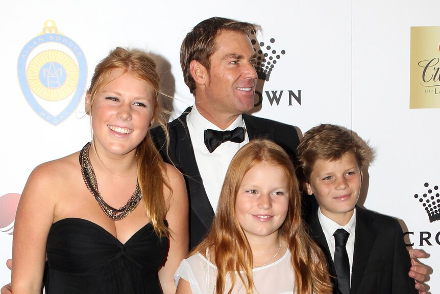 Shane Warne and his three children on the red carpet in 2012.