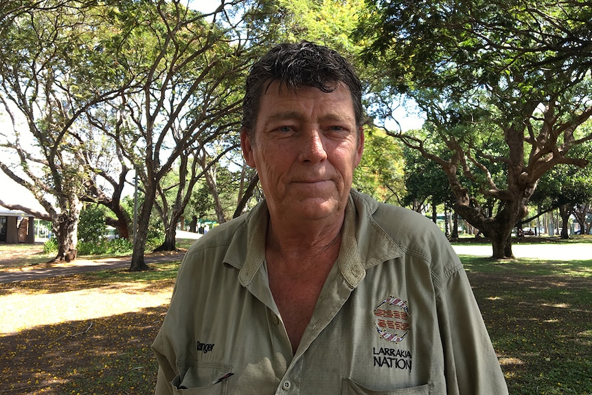 Homeless worker Vaughan Williams wearing a green Larrakia Nation shirt.