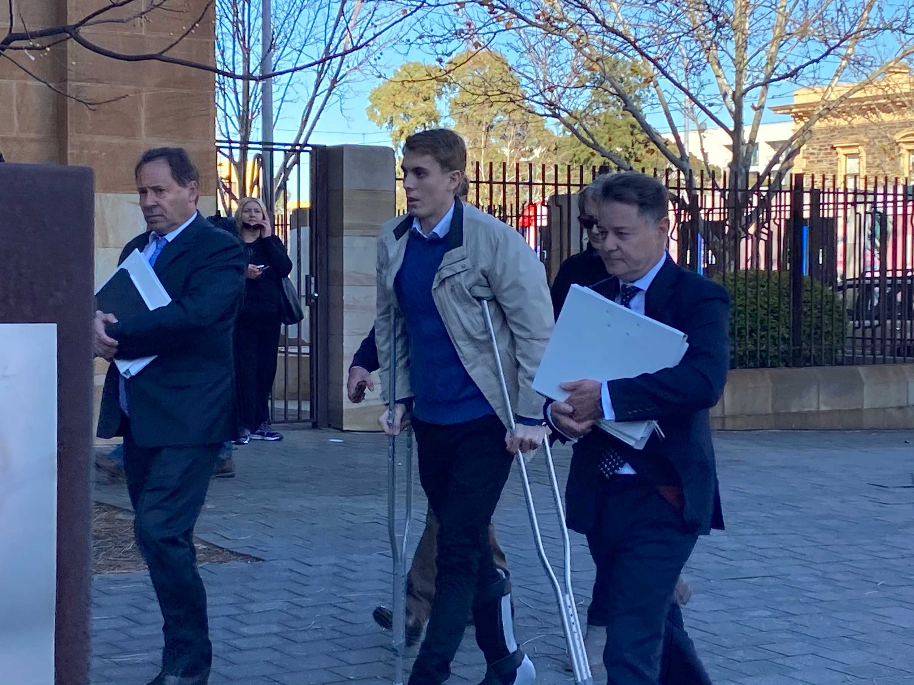 Charged driver Harrison Kitt and others outside an Adelaide court.