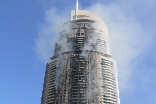 A hotel building on fire.