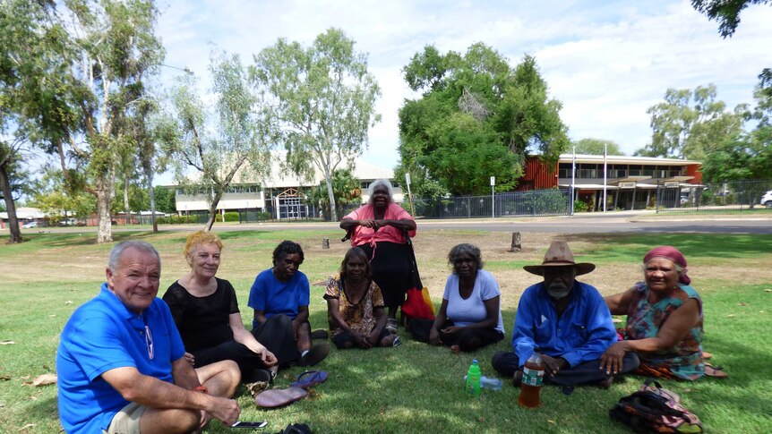 Image of a group of people sitting on the grass outside of the Kununurra Magistrates Court.