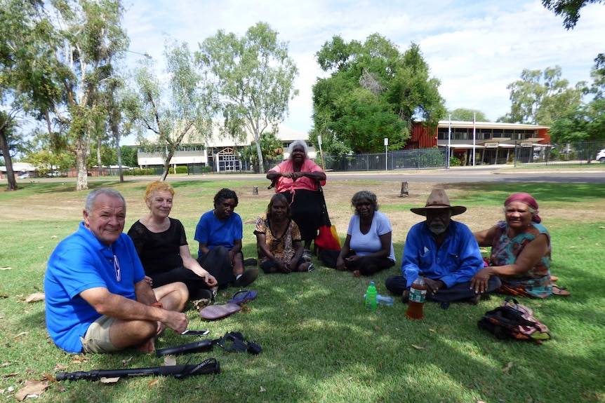 Image of a group of people sitting on the grass outside of the Kununurra Magistrates Court.