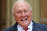 British presenter Stuart Hall poses with his OBE.