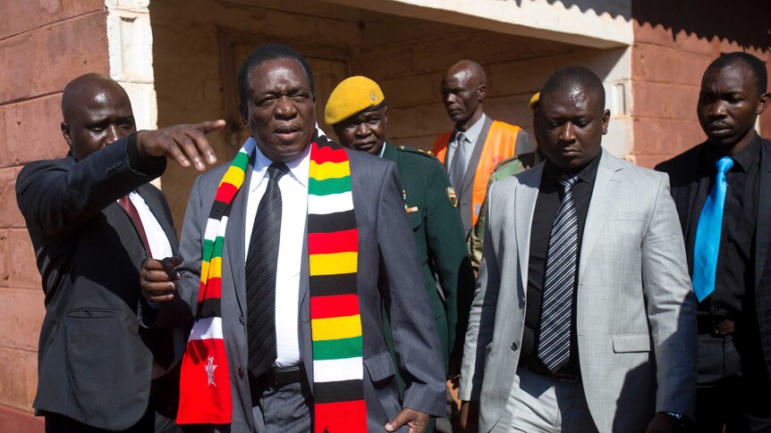 Zimbabwean President Emmerson Mnangagwa leaves the polling station after casting his vote