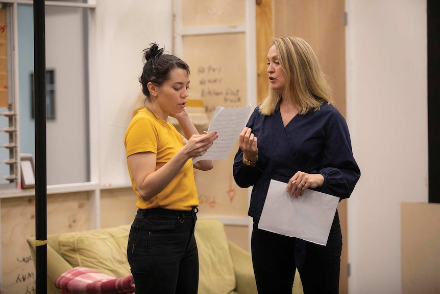 Catherine Van-Davies rehearsing, and reading from paper, with her No Pay? No Way! co-star Helen Thomson.