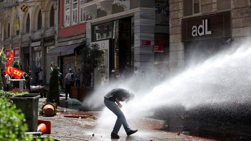 Police use a water cannon to disperse protesters in Istanbul