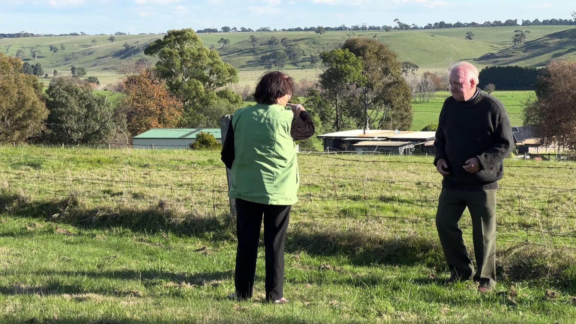 woman and man standing in green paddock