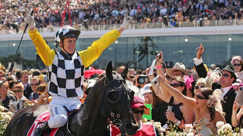 Blake Shinn celebrates with the crowd after riding Viewed to victory.