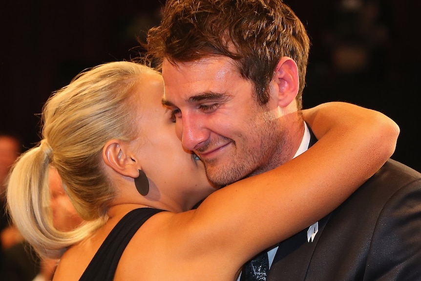 Relax, it's yours: Jobe Watson is congratulated by partner Ella Keddie after his Brownlow triumph is made official.