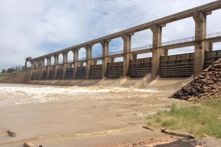 A dam with gates overflowing.