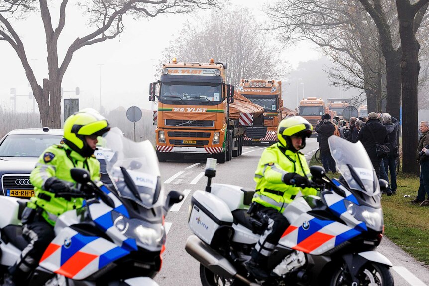 Trucks carry wreckage from Malaysia Airlines flight MH17 into the Netherlands