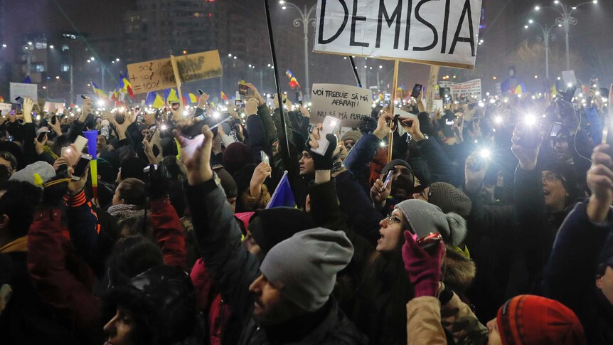Tens of thousands of people shine lights from mobile phones and torches during a protest in Bucharest, Romania.