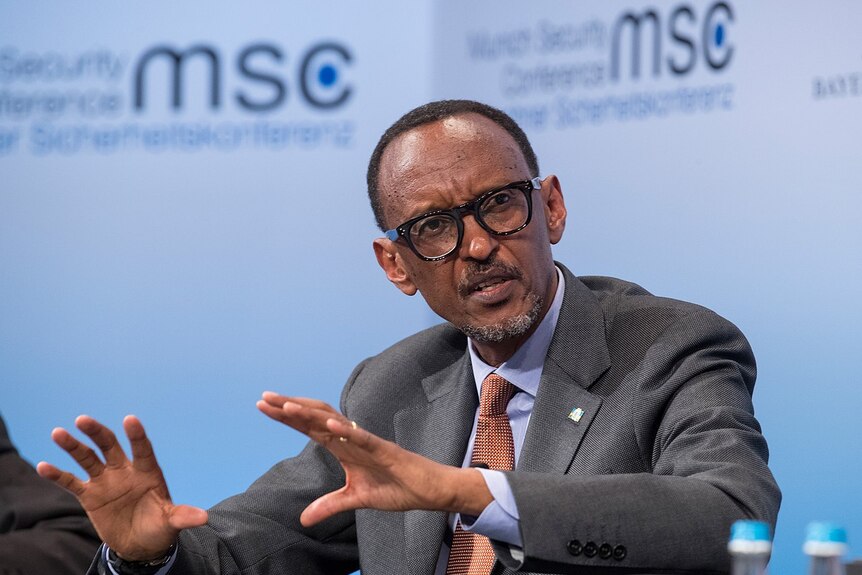Rwandan President Paul Kagame, wearing glasses and a suit, speaks at a conference in 2017.