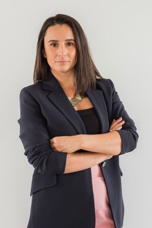 A middle shot of woman with her arms folded