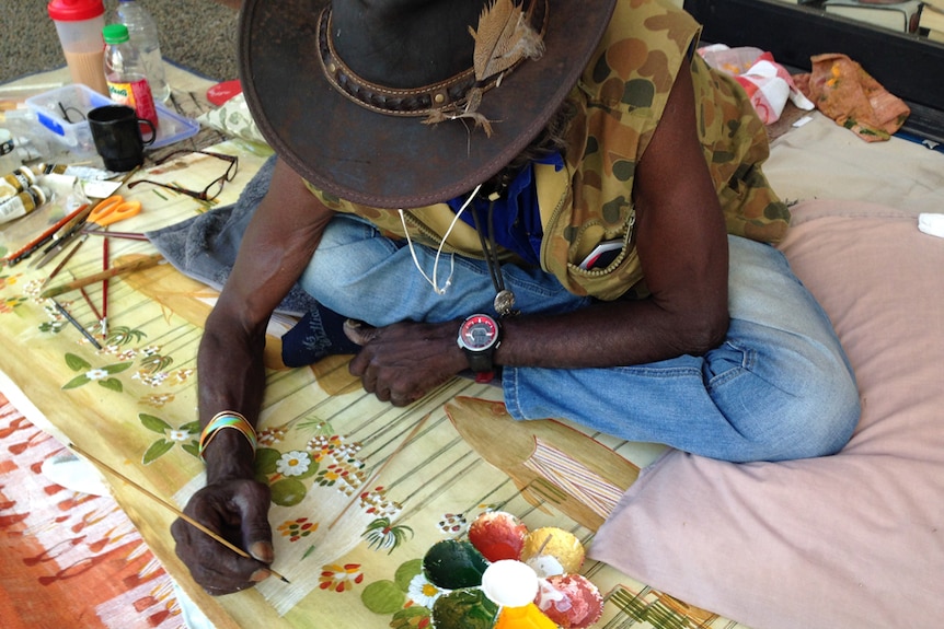 Actor David Gulpilil paints fine lines with a single strand of hair