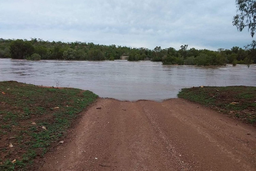 Water over a dirt road.