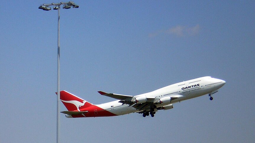 A Qantas jumbo jet takes off from Sydney International Airport