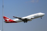 A Qantas jumbo jet takes off from Sydney International Airport