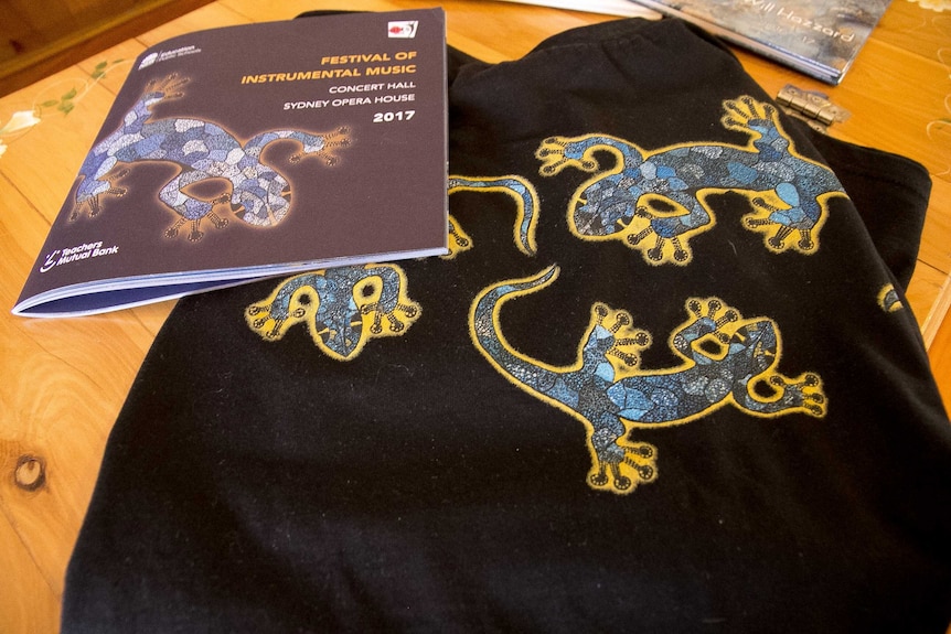 Book and t-shirt featuring a stylised lizard