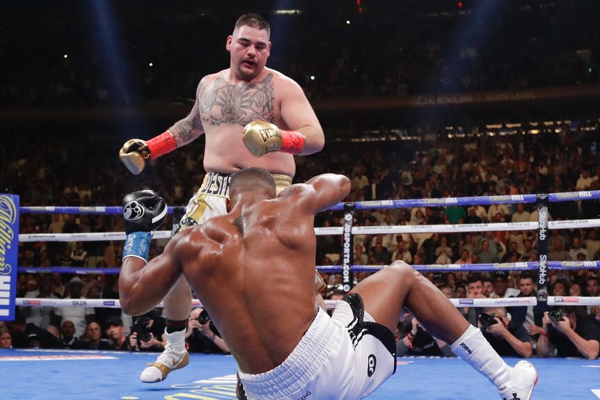 Andy Ruiz stands over Anthony Joshua, who falls to his backside