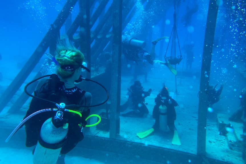 A group of scuba divers at the Museum of Underwater Art