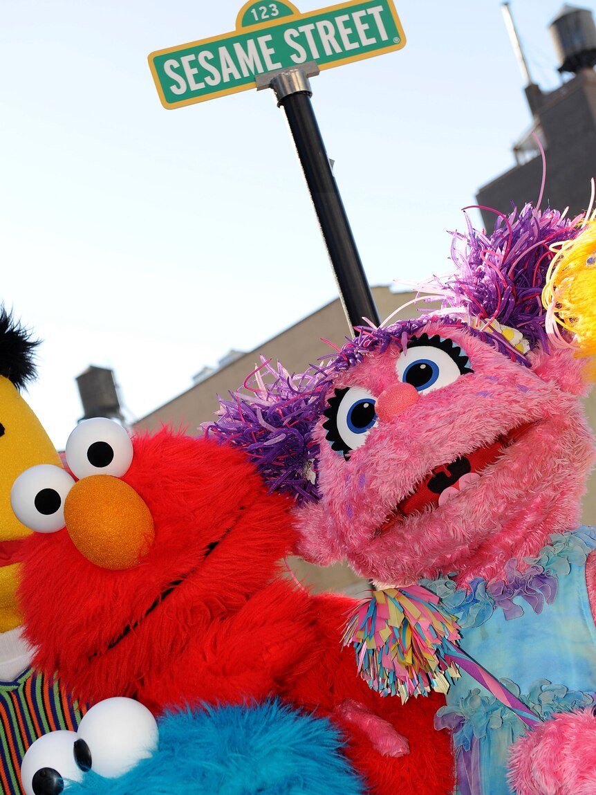 Sesame Street Live characters celebrate the renaming of the corner of 31st Street and Eighth Avenue to Sesame Street.