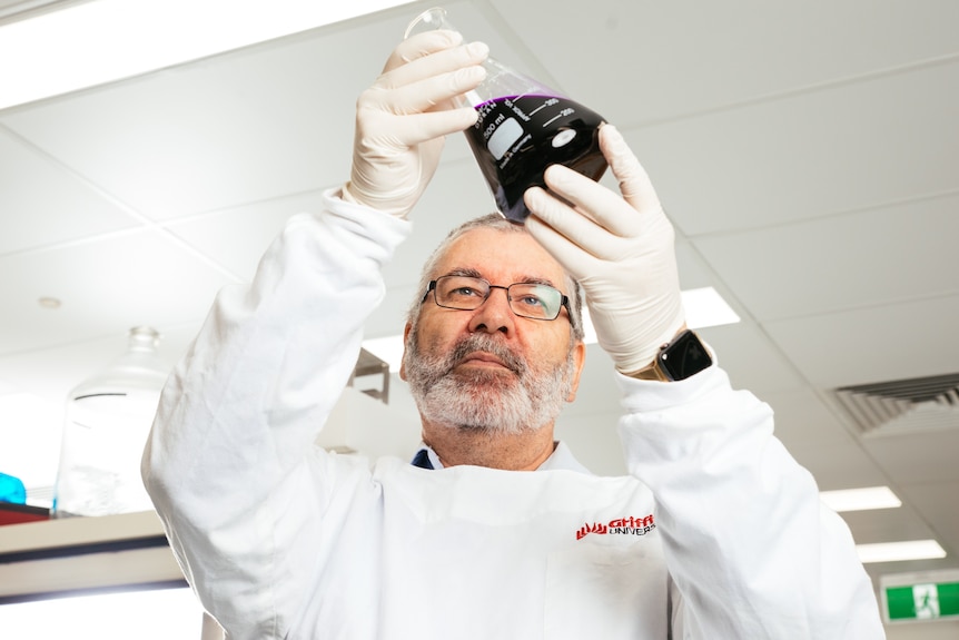 Griffith University Professor Nigel McMillan works in a lab.