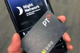 An Android phone with a night network sign on it and a PTV myki card.