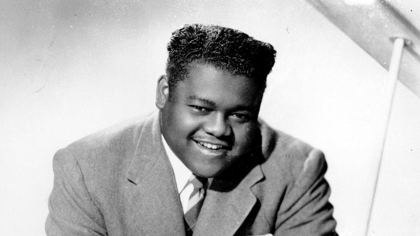 Black and white photo of fats domino at piano