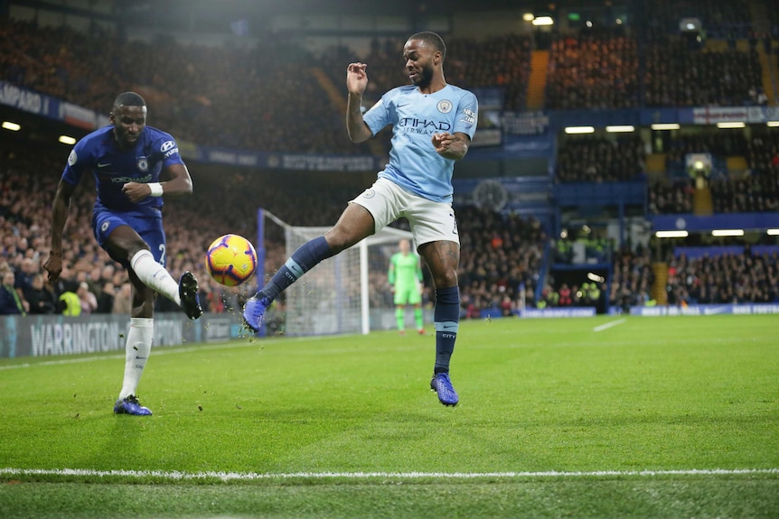Chelsea's Antonio Rudiger and Manchester City's Raheem Sterling compete for the ball