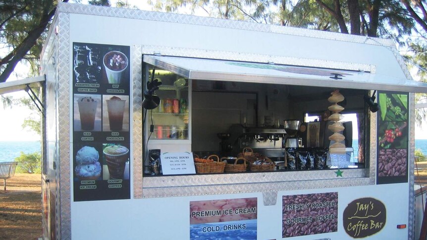 A food van on a beach.