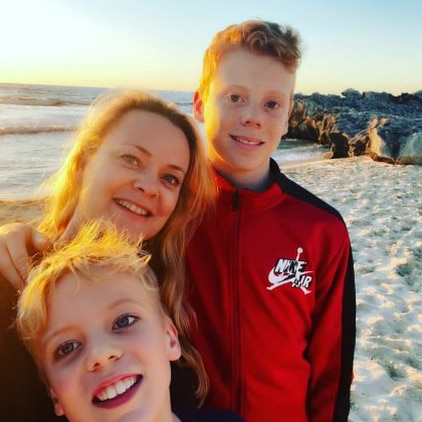 Headshots of a woman and two children on a beach